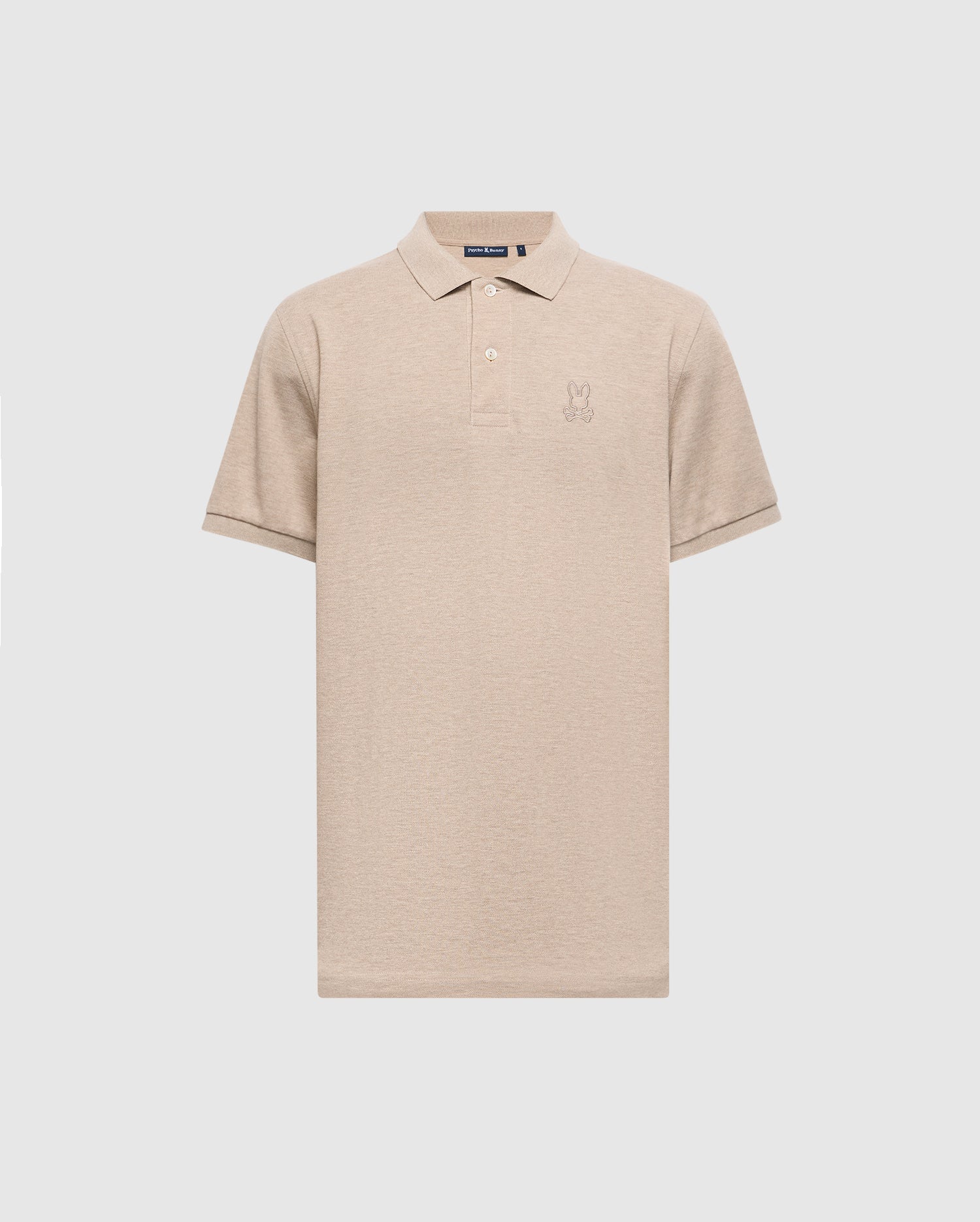 The Psycho Bunny Men's James Premium Pique Polo Shirt - B6K945D200 is a beige, lightweight polo crafted from durable Pima cotton. It includes a collar, short sleeves, and features an embroidered design on the left chest.