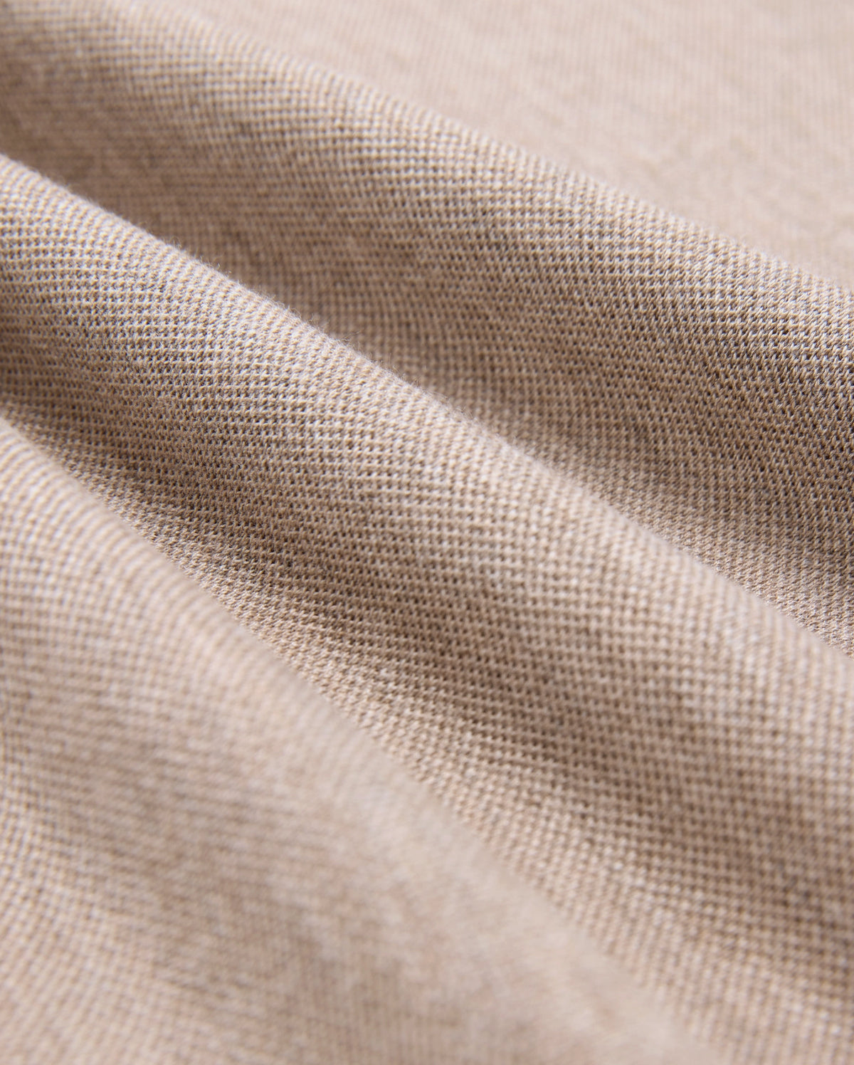 Close-up of Psycho Bunny's MENS JAMES PREMIUM PIQUE POLO SHIRT fabric, crafted from premium materials, showing a fine weave with soft folds. The smooth, uniform texture has gentle undulations and subtle shadows—ideal for a durable yet luxurious wear.