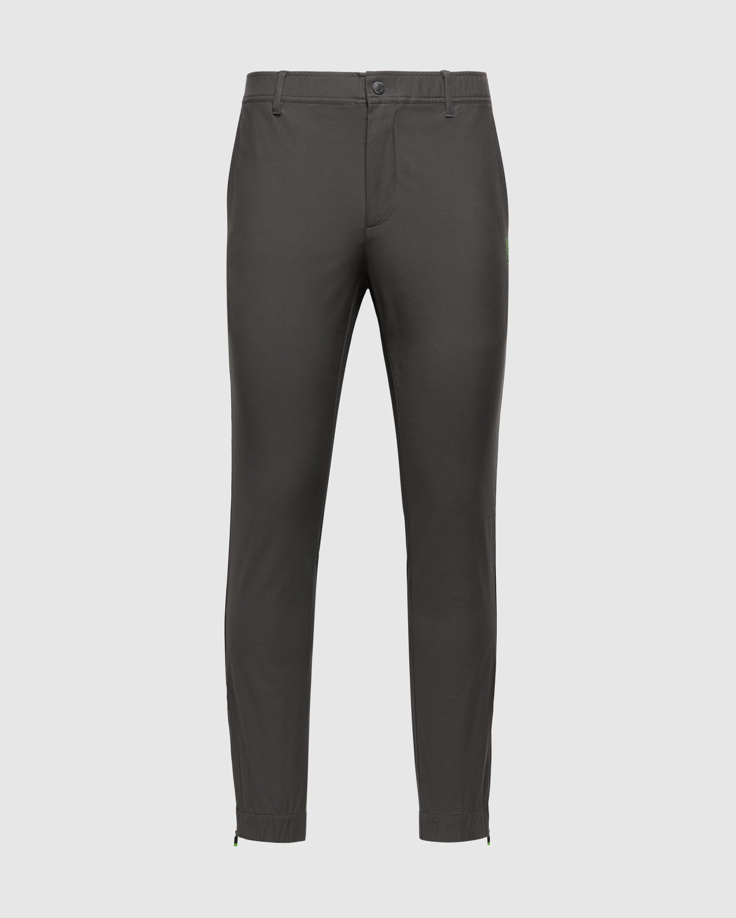 A pair of dark gray MENS MADISON COMMUTER PANT - B6P395Z1WB by Psycho Bunny against a plain background. These slim-fit trousers feature a button and zip closure, belt loops, adjustable hems, and include a detachable Bunny keychain for extra flair.