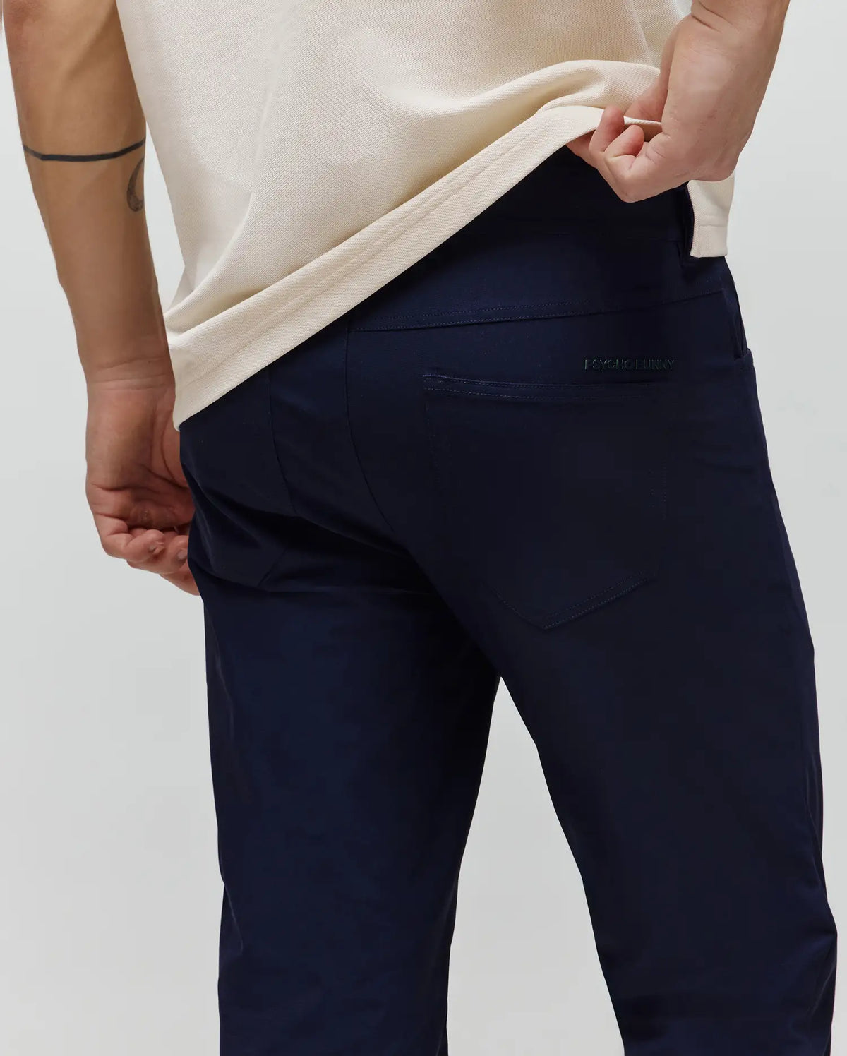 Mens Maverick 10k Step Pant in navy blue, featuring a classic fit, smooth woven fabric, and a subtle embroidered PSYCHO BUNNY text logo above the right back pocket.