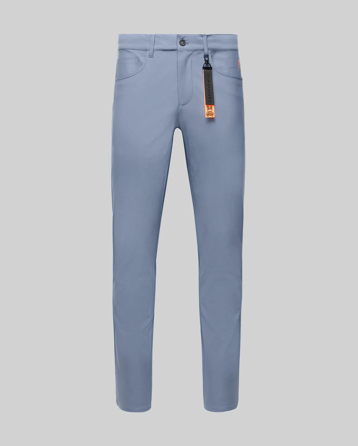 The Psycho Bunny MENS MAVERICK 10K STEP PANT - B6P788D200 is a light blue slim-fit pant with front pockets, belt loops, button closure, four-way stretch, and an orange and black tag on the front right belt loop, shown on a light gray background.