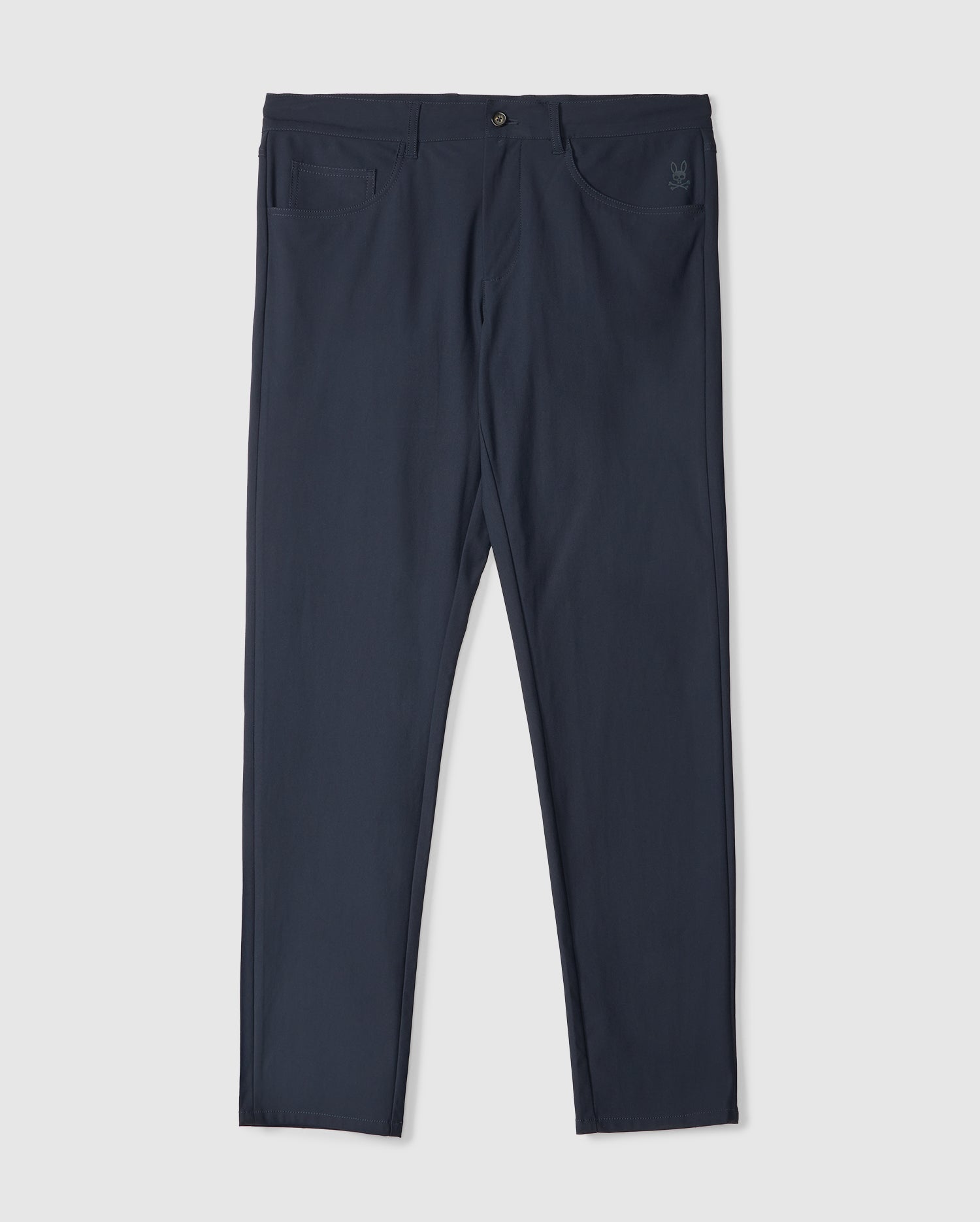 The MENS MAVERICK 10K PANT by Psycho Bunny is shown flat on a white backdrop. The dark blue slim-fit design features button and zipper front closure, two front pockets, and subtle stitching details.