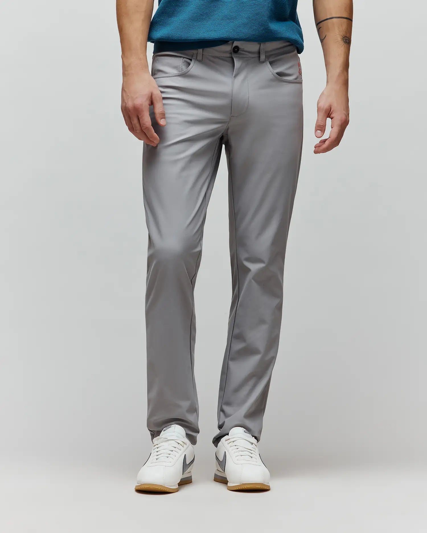 Mens Maverick 10k Step Pant in grey, classic fit, smooth performance fabric, with a small embroidered red Psycho Bunny skull logo on the right hip pocket.