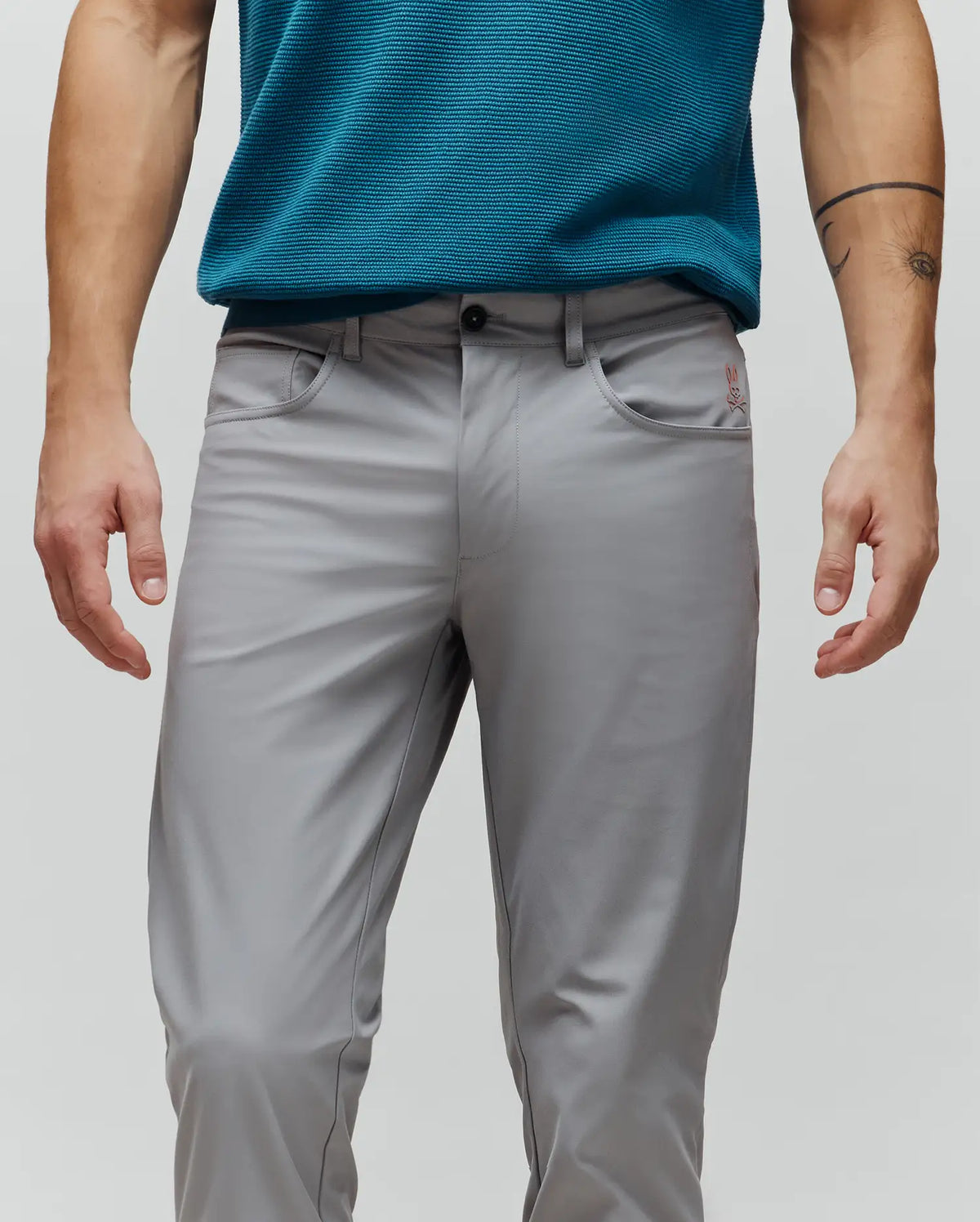 Mens Maverick 10k Step Pant in sleek grey, a classic fit with smooth performance fabric, accented by a small red embroidered Psycho Bunny logo on the right front pocket.