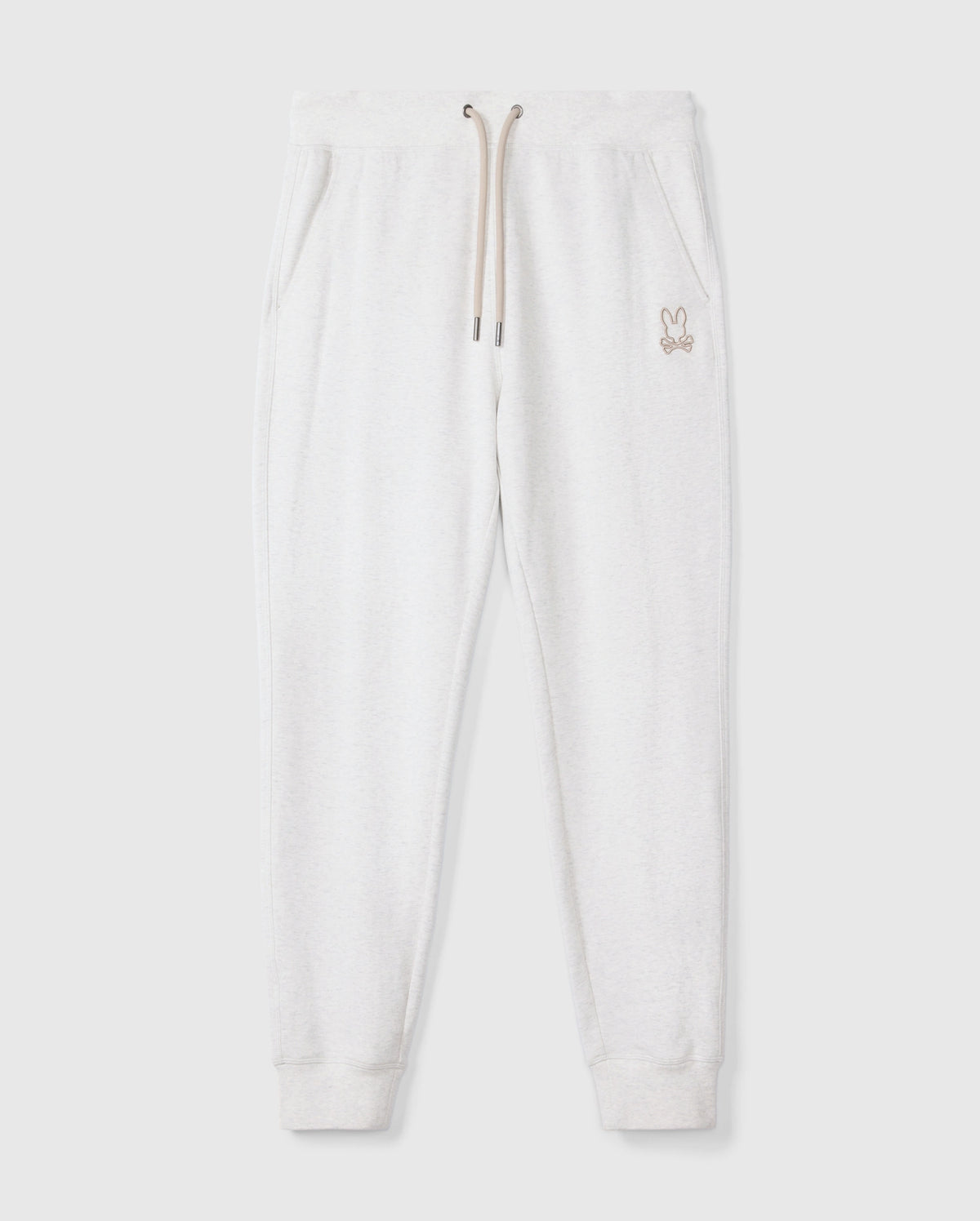 Introducing the MENS JAMES PREMIUM SWEATPANT - B6P791D200 by Psycho Bunny, a stylish pair of light gray cotton-blend sweatpants featuring an embroidered bunny logo on the left thigh. These premium bottoms showcase a relaxed fit with an elastic waistband and beige drawstrings, complemented by two side pockets, all set against a plain white background.