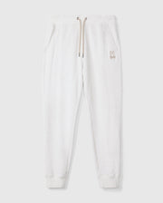 Introducing the MENS JAMES PREMIUM SWEATPANT - B6P791D200 by Psycho Bunny, a stylish pair of light gray cotton-blend sweatpants featuring an embroidered bunny logo on the left thigh. These premium bottoms showcase a relaxed fit with an elastic waistband and beige drawstrings, complemented by two side pockets, all set against a plain white background.