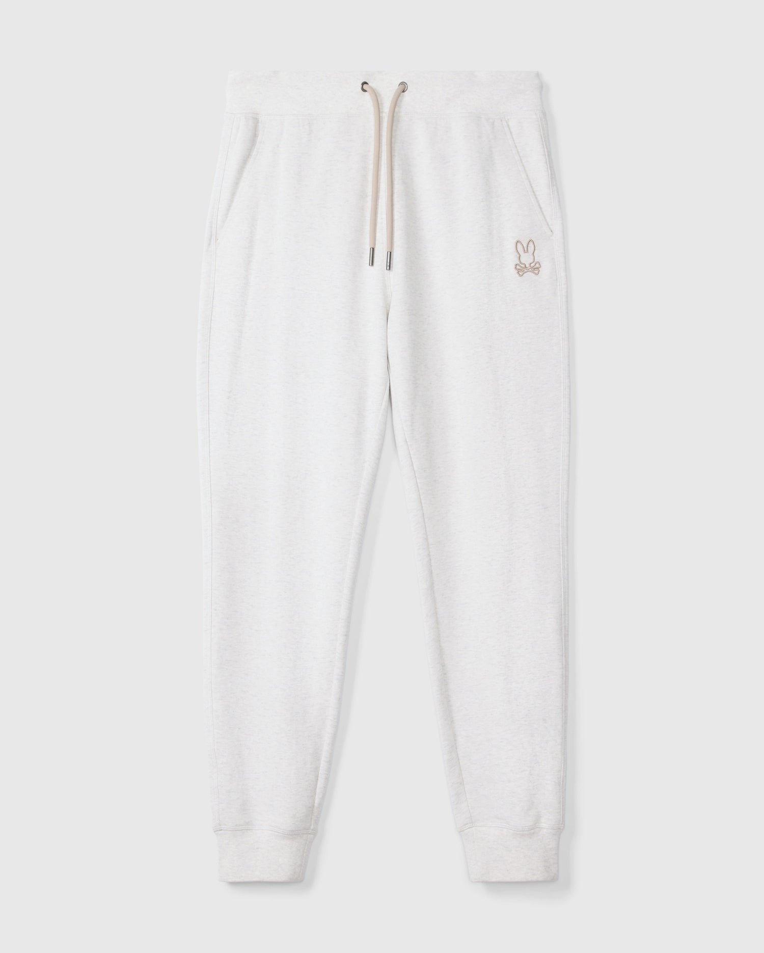 Introducing the MENS JAMES PREMIUM SWEATPANT - B6P791D200 by Psycho Bunny, a stylish pair of light gray cotton-blend sweatpants featuring an embroidered bunny logo on the left thigh. These premium bottoms showcase a relaxed fit with an elastic waistband and beige drawstrings, complemented by two side pockets, all set against a plain white background.