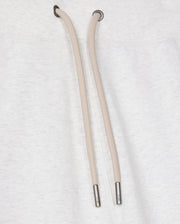 Close-up of a light gray cotton-blend drawstring hoodie featuring two tan drawstrings with metal tips against the fabric. The drawstrings descend from metal eyelets at the neck area, beautifully pairing with Psycho Bunny's MENS JAMES PREMIUM SWEATPANT - B6P791D200 for a stylish and comfortable ensemble.