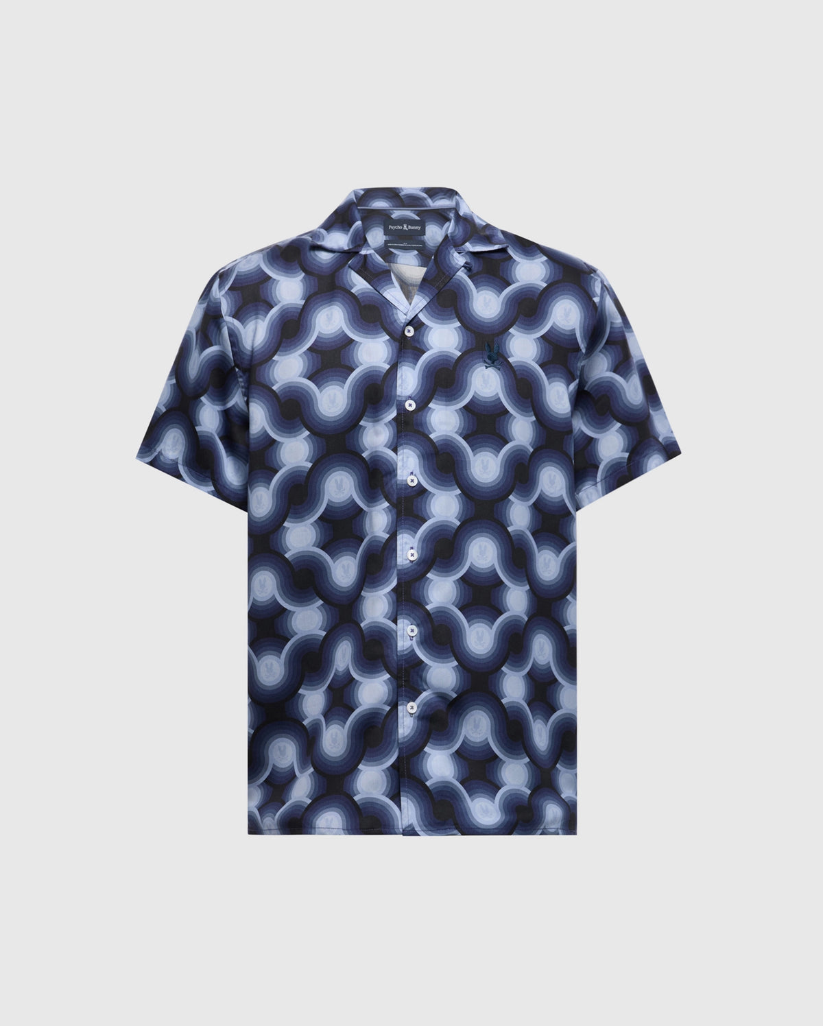 The MENS PAROS TENCEL SHIRT - B6Q460F200 by Psycho Bunny is a short-sleeve button-up styled in a blue and grey retro wave pattern on a light background, crafted from woven Tencel with a classic collar and matching buttons.