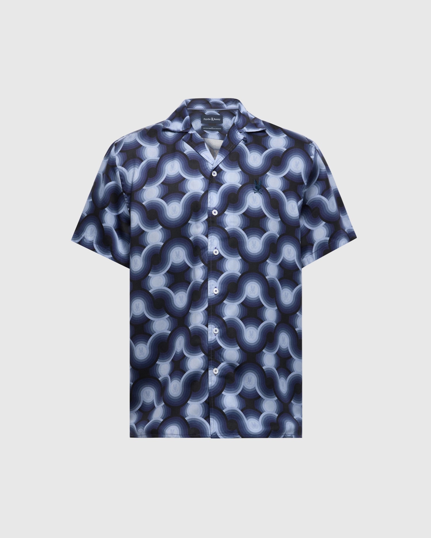 The MENS PAROS TENCEL SHIRT - B6Q460F200 by Psycho Bunny is a short-sleeve button-up styled in a blue and grey retro wave pattern on a light background, crafted from woven Tencel with a classic collar and matching buttons.