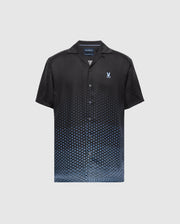 The MENS BENDIGO TENCEL SHIRT - B6Q627F200 by Psycho Bunny is a black short-sleeve shirt with an ombre blue hexagon pattern, made from soft Tencel fabric. It features a camp collar and a small embroidered logo on the chest against a plain white background.