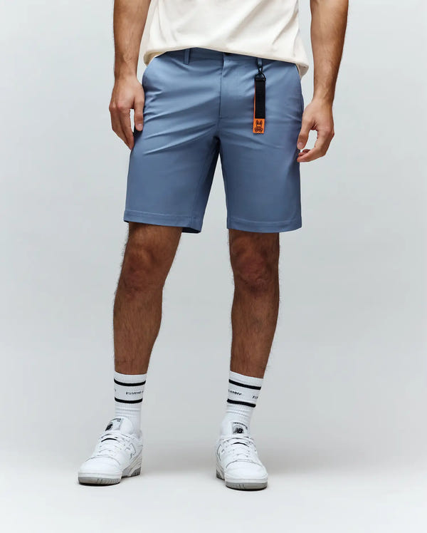 Mens Maverick 10k Step Short in slate blue, a classic fit short made from smooth performance fabric, featuring an attached orange and black Psycho Bunny skull logo keychain.
