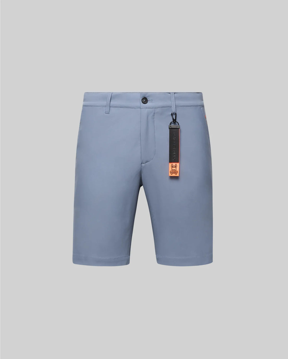 Mens Maverick 10k Step Short in dusty blue, a classic fit with smooth performance fabric, button closure, and a black and orange Psycho Bunny logo keychain, plus a small red side tag.