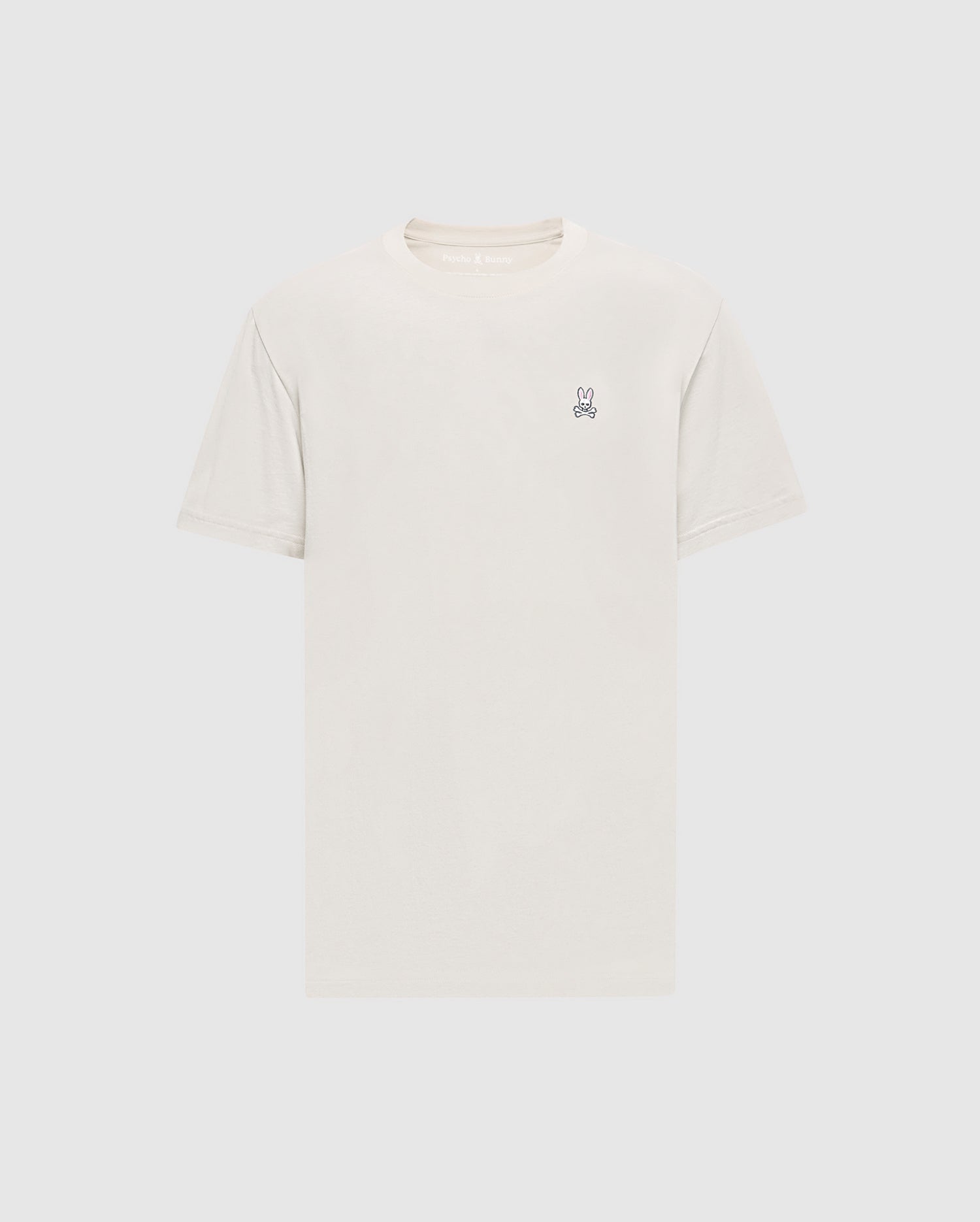 The Psycho Bunny Men's Classic Crew Neck Tee (B6U014B200) in light beige is a premium Pima cotton shirt with short sleeves and an embroidered bunny logo on the upper left chest. Set against a simple white background, it embodies timeless appeal.
