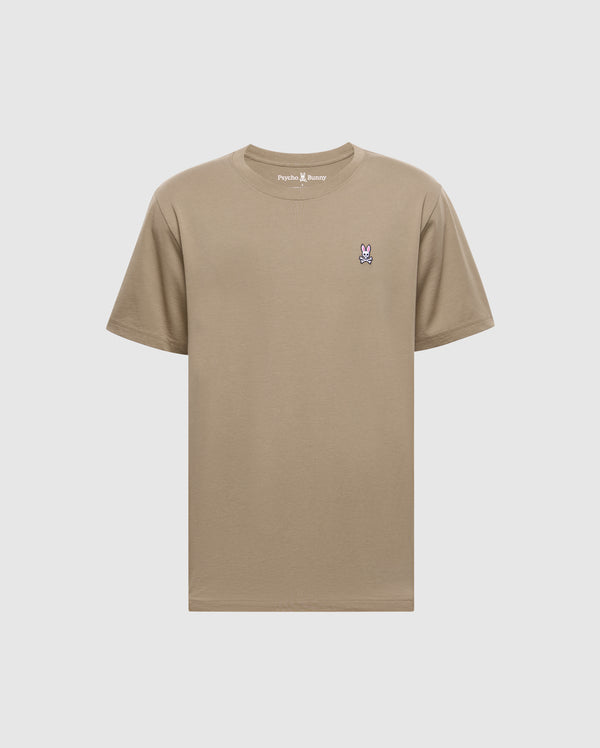 The Psycho Bunny Men's Classic Crew Neck Tee (B6U014CRPC) is a wardrobe essential made from 100% Pima cotton in beige, featuring a purple and white embroidered bunny logo on the left chest and a matching beige rib-knit trim for style.