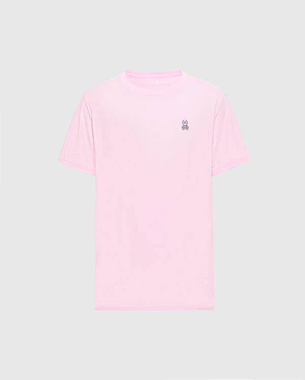 The light pink Men's Classic Crew Neck Tee (B6U014CRPC) by Psycho Bunny is crafted from soft pima cotton with a small embroidered peace sign hand symbol on the top left chest against a plain gray background, making it versatile and stylish for any casual occasion.
