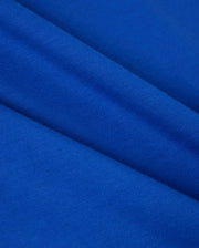 A close-up of the Pima cotton fabric from the Psycho Bunny MENS CLASSIC CREW NECK TEE - B6U014CRPC reveals its smooth texture and diagonal folds. The fabric looks soft and uniform, exhibiting a rich, consistent blue hue throughout—ideal for creating a cozy crewneck tee.