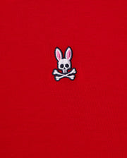 The MENS CLASSIC V NECK TEE - B6U100CRPC from Psycho Bunny showcases a red fabric made of soft Pima cotton and features the brand's signature logo: a white skull and crossbones with playful pink bunny ears.
