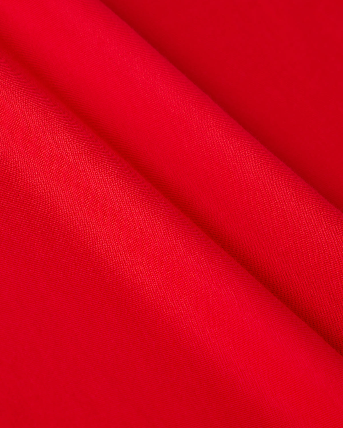 Close-up of the vibrant red Pima cotton fabric from the Psycho Bunny Men's Classic V-Neck Tee - B6U100CRPC, showcasing a smooth and even texture. Slight folds create gentle shadows, highlighting its sheen and refined appearance.
