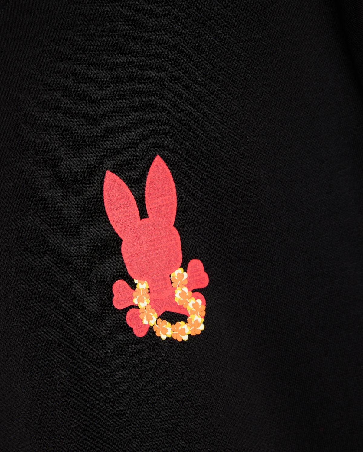 Introducing the Psycho Bunny Hawaii City Tee (product code: B6U169Y1PC) for men, a premium Pima cotton T-shirt featuring a black base with an eye-catching pink bunny silhouette and crossbones design, highlighted by a striking yellow floral wreath around its neck. This distinctive piece is perfect for adding a unique flair to any wardrobe.