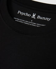 Close-up of the MENS HAWAII CITY TEE by Psycho Bunny, highlighting the black label inside the collar featuring its iconic logo and text indicating it's crafted from 100% Pima cotton, made in Peru.