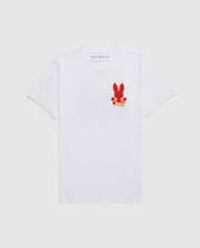A white MENS HAWAII CITY TEE - B6U169Y1PC with short sleeves featuring a small red graphic of a bunny on the left chest area. The graphic includes yellow and orange floral details. Made from soft Pima cotton jersey, the label inside the collar reads "Psycho Bunny." The shirt is displayed against a plain white background.