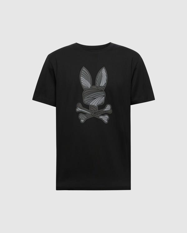 The Psycho Bunny MENS BAXTER GRAPHIC TEE (B6U409F200) is a black Pima cotton shirt featuring a stylized gray bunny head with long ears above crossed bones, centered on the chest against a plain light gray background.