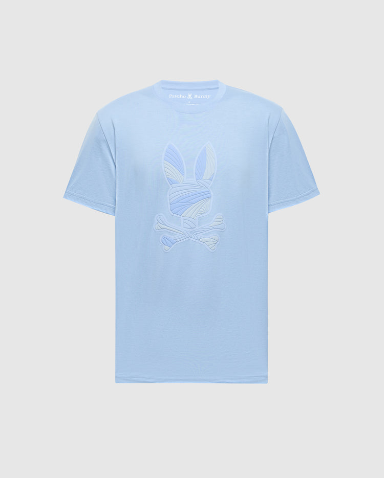 The Psycho Bunny MENS BAXTER GRAPHIC TEE (B6U409F200) is a light blue Pima cotton shirt with a stylized bunny skull and crossbones graphic on the front, shown against a plain white background.