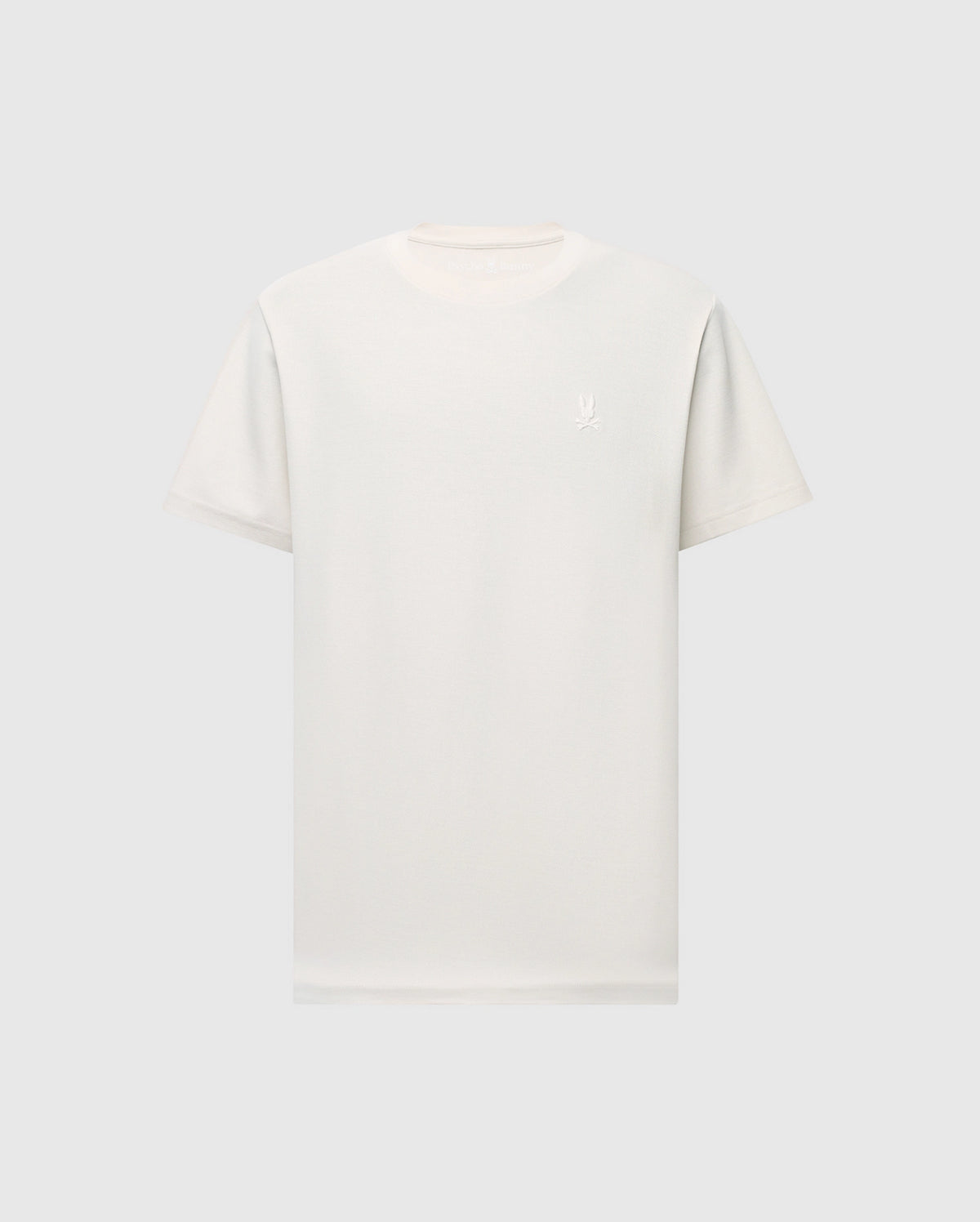 The MENS TAYLOR PIQUE TEE by Psycho Bunny is a plain white, regular fit shirt, made from lightweight Pima cotton with a round neckline and short sleeves. It displays a small, subtle embroidered chest bunny logo on the upper chest and is set against a light gray background.