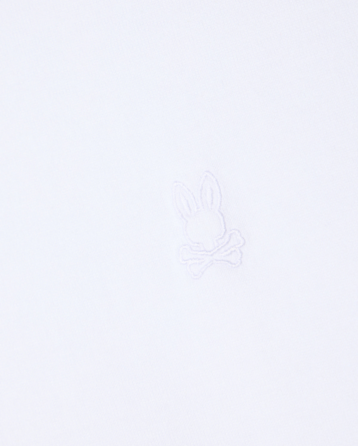 The MENS DUKE OVERSIZED TEE - B6U742D200 by Psycho Bunny is crafted from heavyweight Pima cotton and features a subtle, minimalist embroidered logo in the center, showcasing a bunny head above crossed bones. The matching white embroidery seamlessly blends with the fabric, providing a relaxed fit.