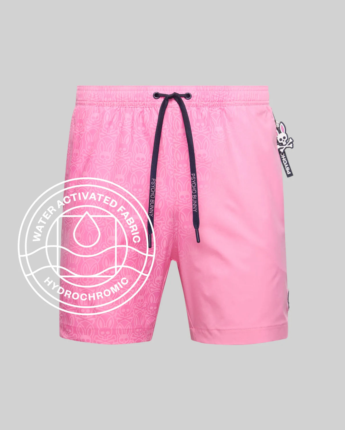 Mens Samos Hydrochromic Printed Swim Trunk in vibrant pink, revealing a water-activated Psycho Bunny skull and crossbones pattern, with navy drawstrings featuring Psycho Bunny text and a small logo tag. (1)