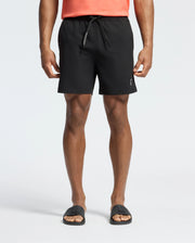 Black Mens Samos Hydrochromic Printed Swim Trunk with a classic fit, featuring a smooth fabric, white PSYCHO BUNNY text on the drawstring, and a small silver bunny skull logo on the lower left leg.