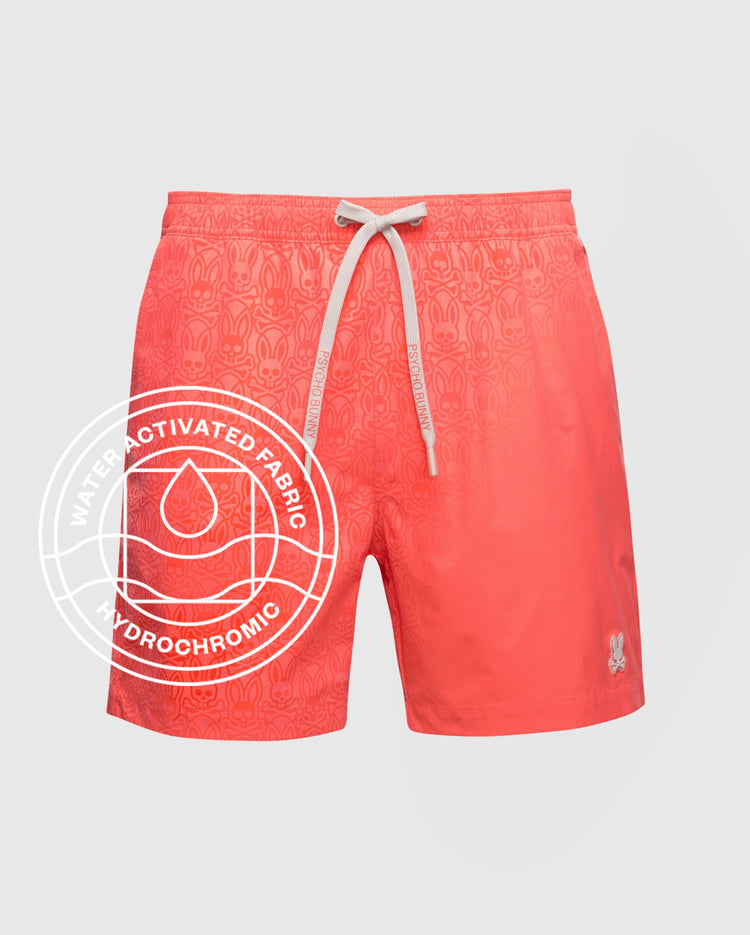 Psycho Bunny MENS SAMOS HYDROCHROMIC SWIM TRUNK - B6W453F200: Coral trunks with a white drawstring, faded pattern, and small embroidered logo. 