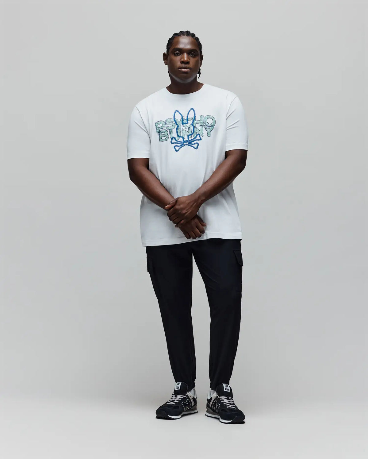 Mens Big And Tall Herman Graphic Tee: White, classic fit, jersey knit t-shirt featuring a large, textured blue and teal Psycho Bunny skull logo and text graphic on the chest.