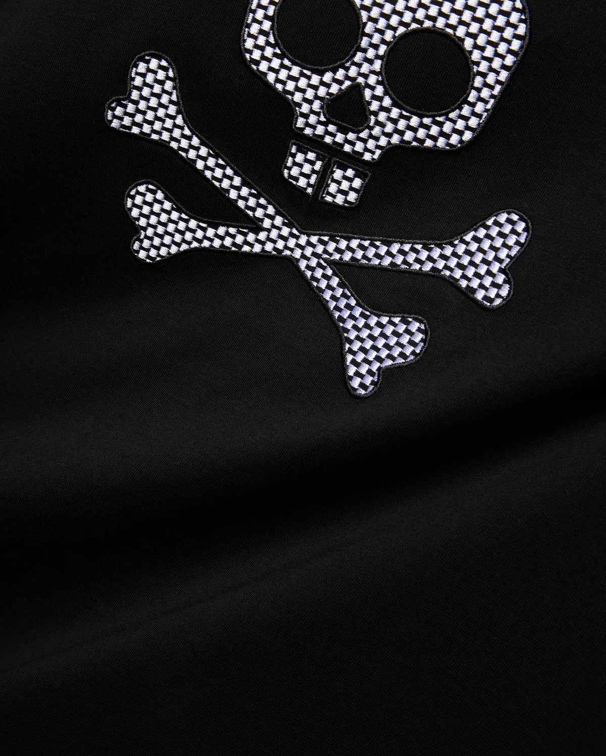 Mens Big And Tall Stan Graphic Tee featuring a black jersey fabric with a large, embroidered white and black checkered skull and crossbones graphic on the chest, offering a relaxed fit. (2)