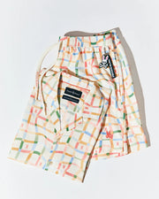 Mens Atlas Swim Trunk and matching short-sleeve shirt in cream multicolor plaid, with subtle pink Psycho Bunny skull logos. Drawstring and keychain feature Psycho Bunny branding.