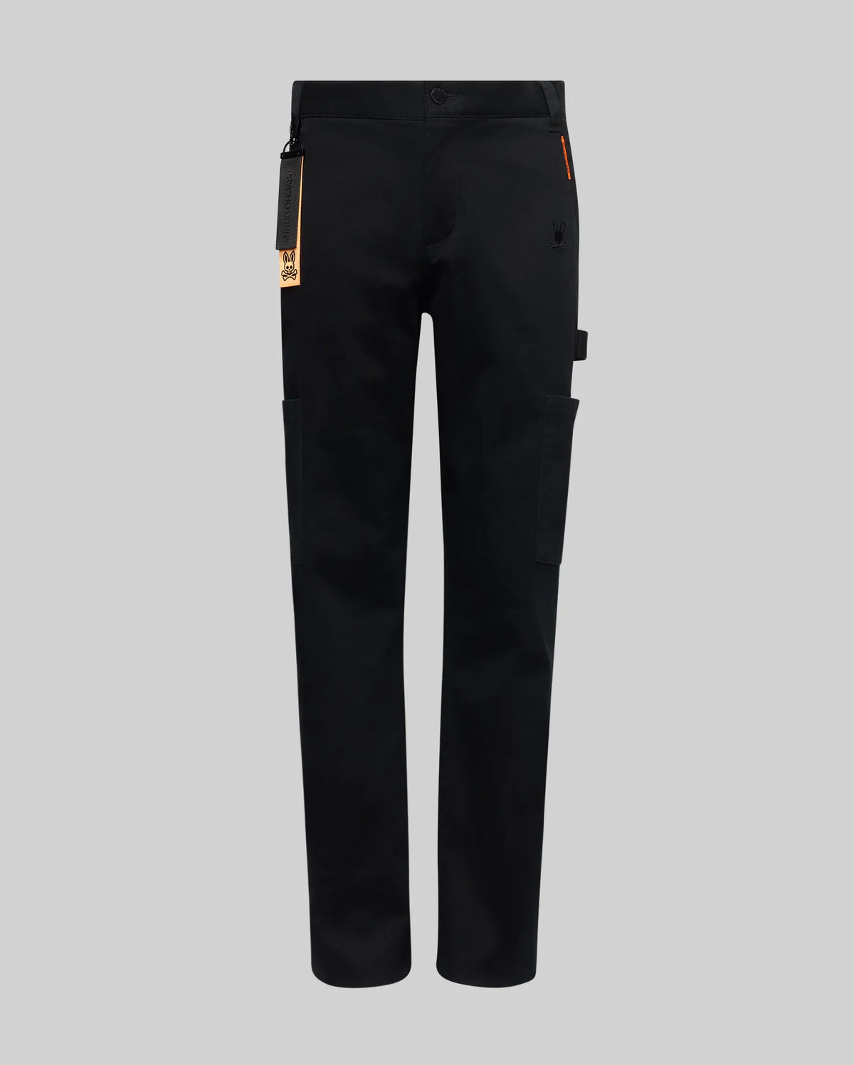 The KIDS RUSSELL CARPENTER PANT - KB0600001 by Psycho Bunny features a regular fit, straight-leg design, side cargo pockets, and a small orange tag on the waistband, shown against a plain grey background.