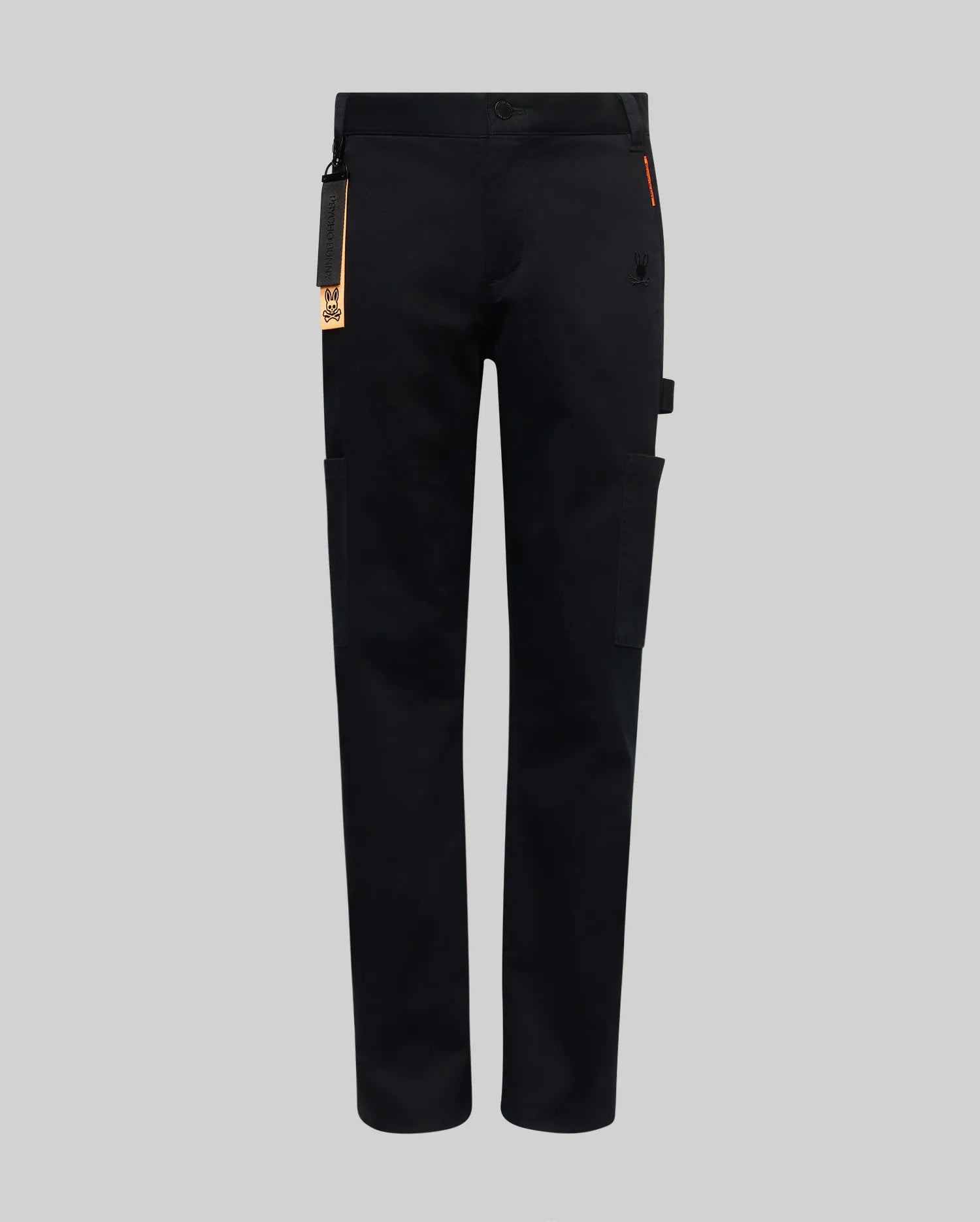 The KIDS RUSSELL CARPENTER PANT - KB0600001 by Psycho Bunny features a regular fit, straight-leg design, side cargo pockets, and a small orange tag on the waistband, shown against a plain grey background.