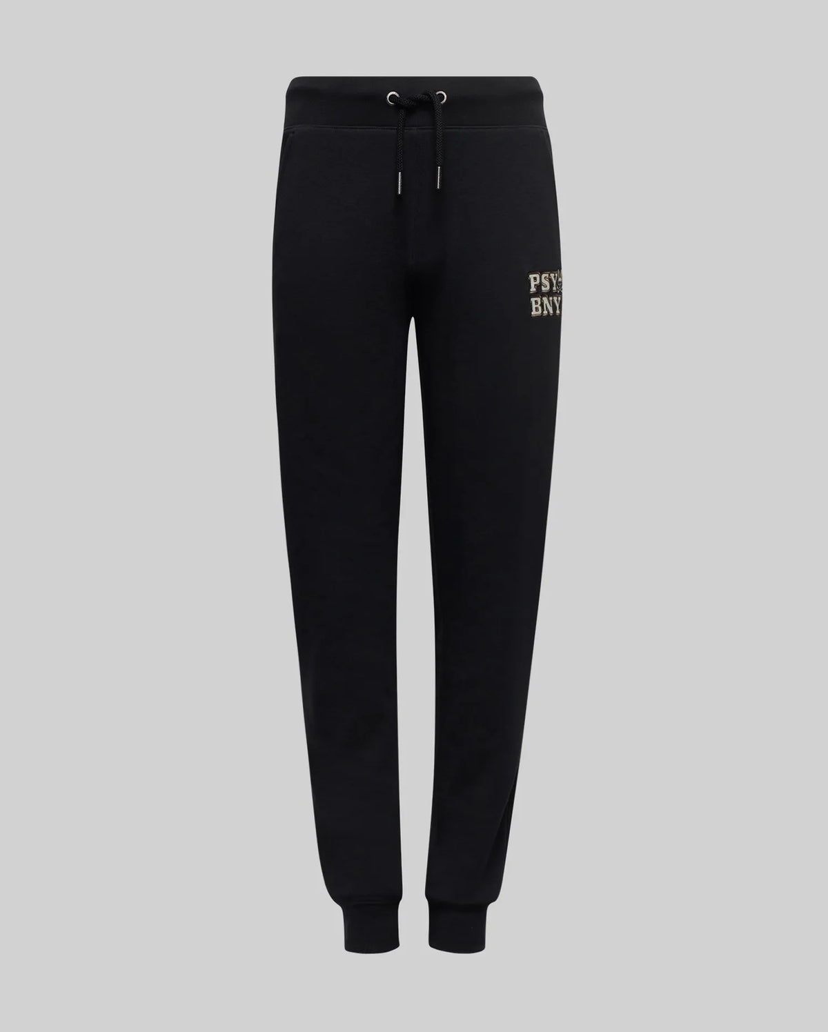 The Psycho Bunny KIDS WADE SWEATPANT (KB0800002) features black jogger pants with an elastic waistband, drawstrings, cuffed ankles, and a small beige embroidered wordmark on the upper left thigh, made from a premium cotton blend.