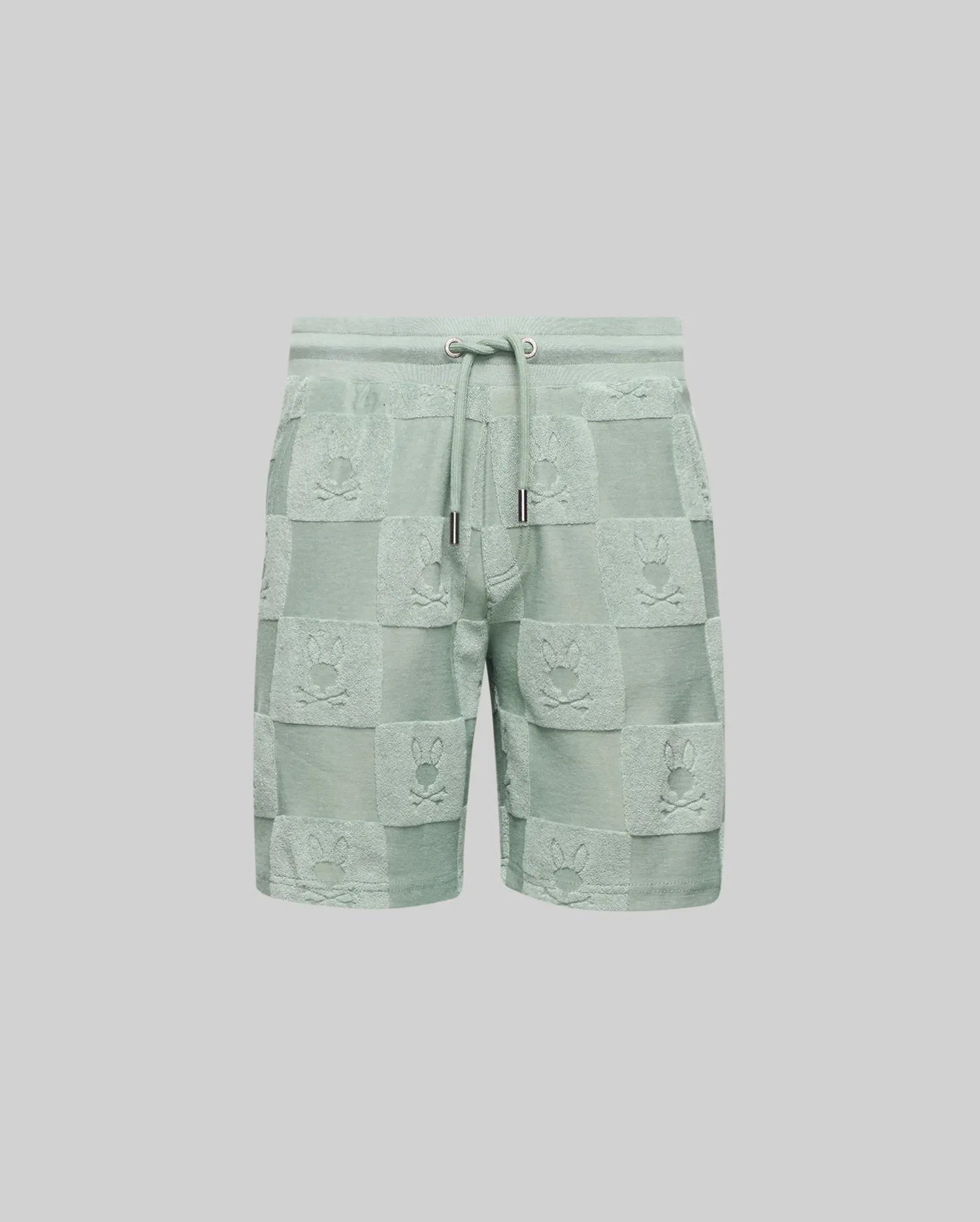 The Psycho Bunny KIDS KELVIN TOWEL TERRY SWEATSHORT - KB0900002 features light green jacquard terry cloth with a checkered bunny pattern, textured bunny faces, and an elastic drawstring waistband with metallic tips.