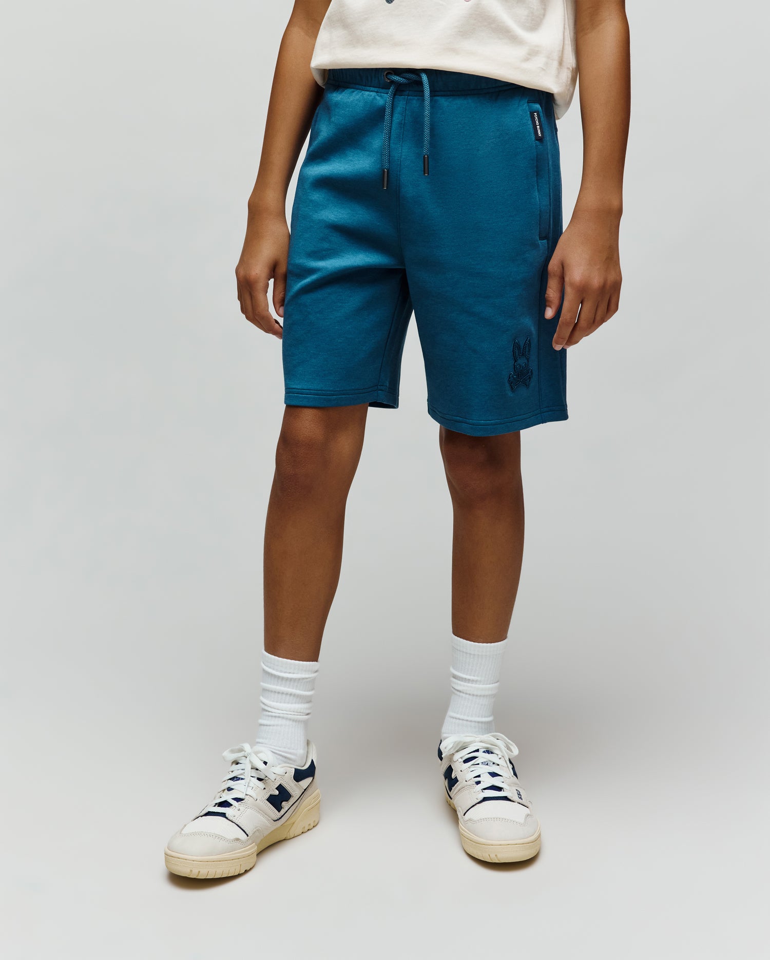 Kids Barry Modal Short in deep teal, featuring a relaxed fit, soft modal French terry fabric, tonal drawstring, side pockets, and a small embroidered tonal bunny skull logo on the left leg.