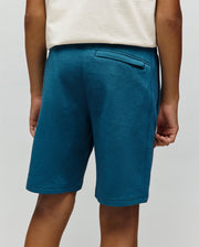 Kids Barry Modal Short in heathered teal, featuring a relaxed fit, soft modal knit fabric, and a zippered back pocket with subtle side pockets.