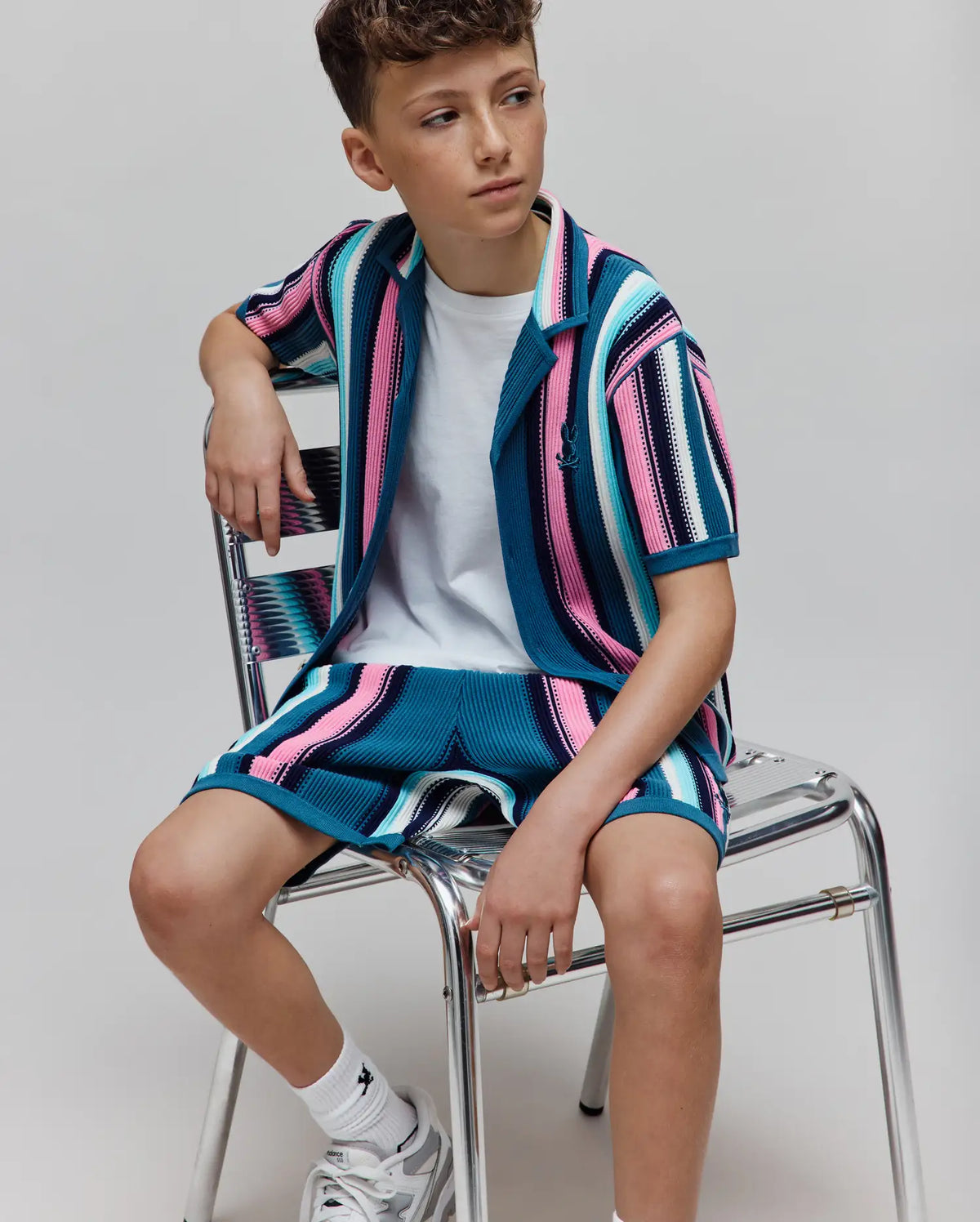 Kids Cliff Knit Short and matching collared shirt in a relaxed fit, featuring bold teal, pink, white, and navy vertical stripes with a ribbed knit texture and small embroidered Psycho Bunny skull logo on the left chest. (3)