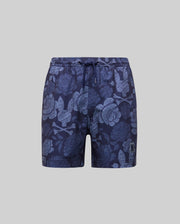 Psycho Bunny KIDS ROWEN SWIM TRUNK (KB1000009) in navy with light blue floral and leaf print, quick-dry fabric, drawstring waist, and small embroidered logo on the left leg, shown on a plain gray background.