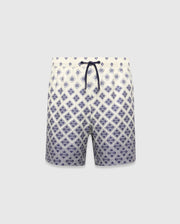Kids Tobias Swim Trunk in cream with a navy blue diamond grid pattern featuring repeated Psycho Bunny skull logos, a relaxed fit, and a navy drawstring. The pattern intensifies towards the hem. (5)