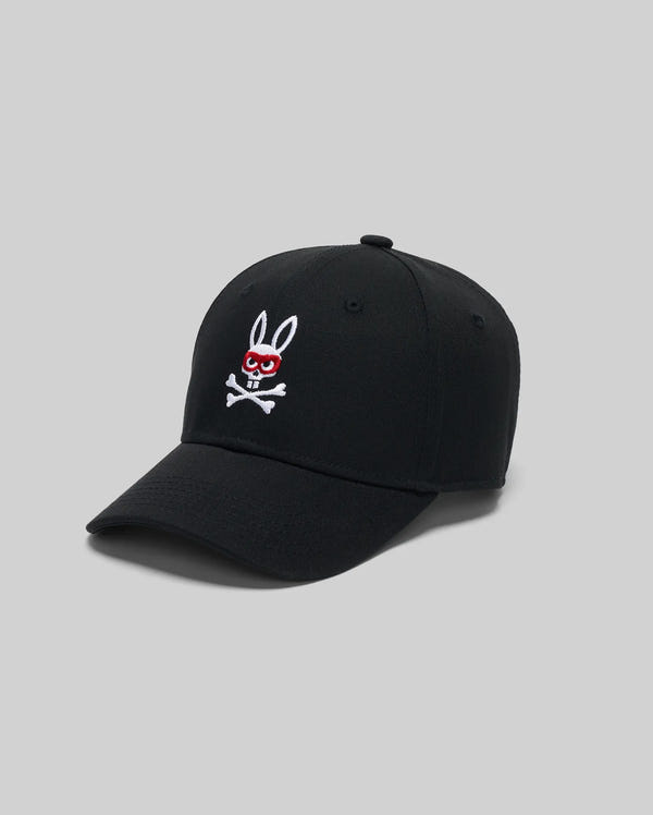 The Psycho Bunny KIDS MISCHIEF BASEBALL CAP (KO1500013) is made of 100% cotton and features an embroidered white Mischief Bunny with red eyes and crossbones on the front, shown against a plain gray background.