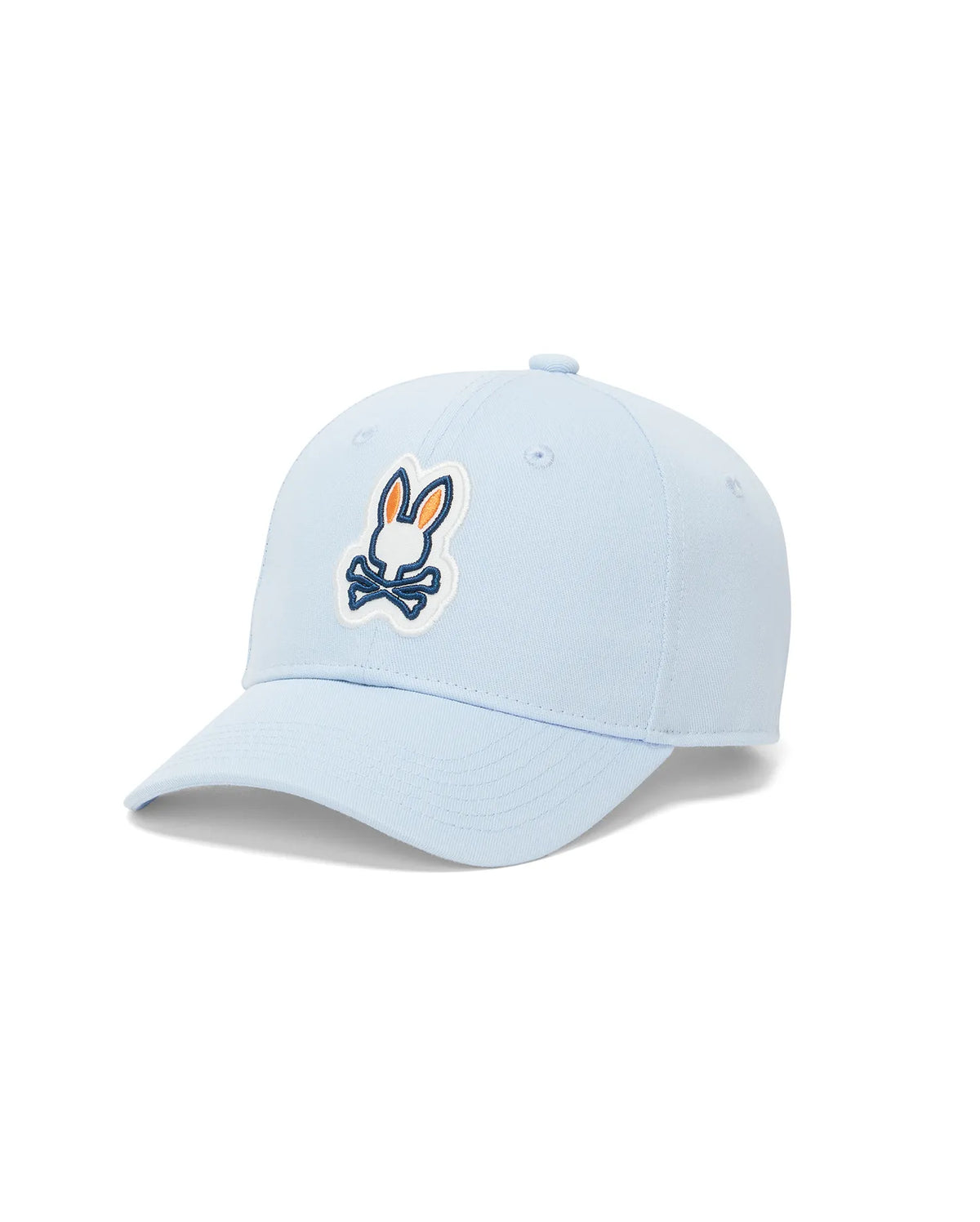 Kids Jaydon Baseball Cap in light blue cotton twill, featuring a prominent front-center embroidered Psycho Bunny skull logo patch with orange ears, dark blue outline, and white background. (2)