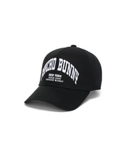 Black Kids Nathaniel A-Frame Trucker Cap with bold white arched embroidered Psycho Bunny New York Since 2005 text prominently on the front, showcasing premium streetwear style. (2)