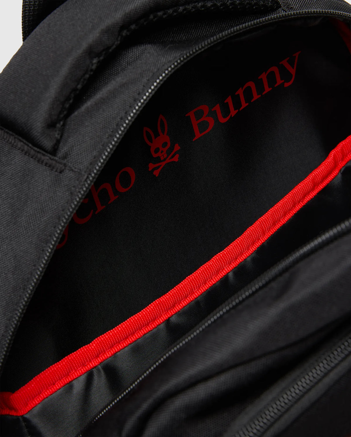 Black Kids Pal Backpack with a durable synthetic exterior. The interior lining is black with a large, bold red Psycho Bunny skull logo and text, accented by a vibrant red webbing trim along the zipper. (2)