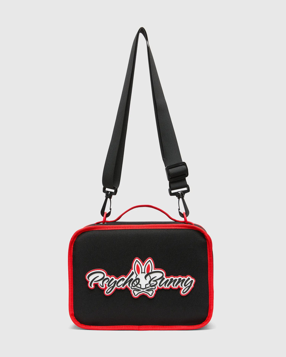 Kids Pal Lunch Box, black with vibrant red piping, featuring a prominent white and red embroidered Psycho Bunny skull logo on the front, complete with an adjustable black strap and red carry handle. (4)